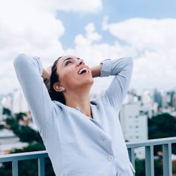 Young Brazilian business woman relieved after work.